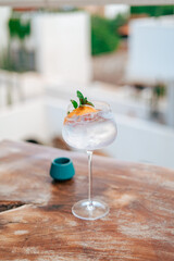 Refreshing gin and tonic k drink becomes a classic cocktail with garnish served in an elegant...