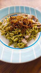 Vertical shot of a dish of homemade spaetzle or german egg noodle dumplings