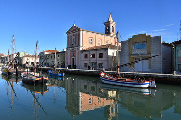 Fototapeta na wymiar Ancient beautiful boats on canal Port in Cesenatico in Emilia Romagna in Italy created by Leonardo da Vinci 