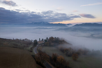 Aerial view of foggy morning in Marche region in Italy