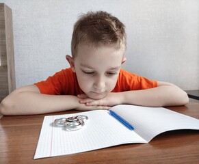 Tired boy with ADHD is bored in class, distracted, does not want to do homework. Therapy for ADHD...