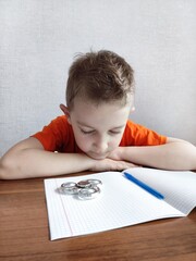 Tired boy with ADHD is bored in class, distracted, does not want to do homework. Therapy for ADHD...