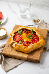 Close up of tomatoes savory pie on wooden board