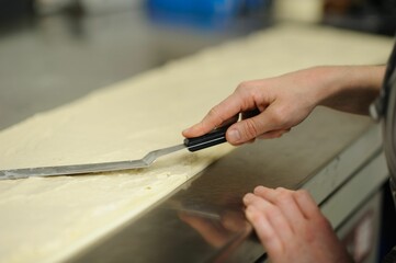 Closeup of hands making dessert in a bakery