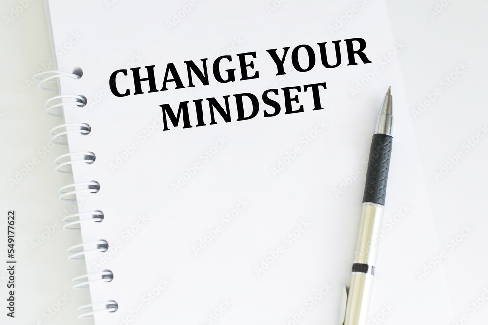 Poster change your mindset text notepad and on office white table