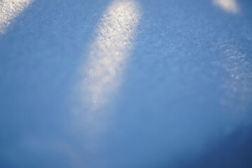 Snow on the car window. Snowflakes covered the car in a thick layer. The frozen car. Selective focus.