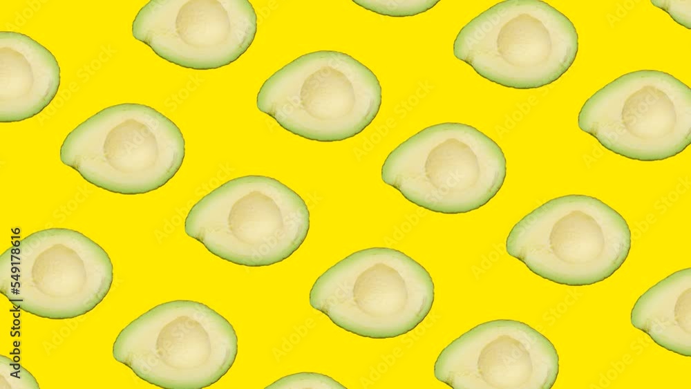 Poster a half of avocado in seamless loop pattern on a yellow background. exotic fruits in seamless loop an
