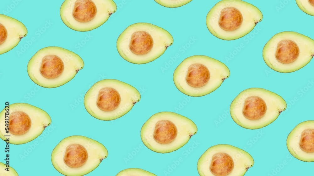 Poster a half of avocado with seed in seamless loop pattern on a light blue background. exotic fruits in se