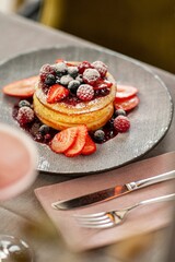 Delicious pancakes with berries on a plate