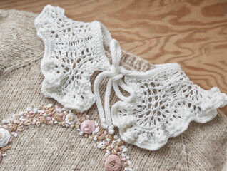 Baby knitted clothes. Handmade knitted clothes with embroidery.