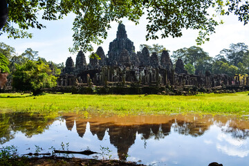 Fototapeta na wymiar Angkor Thom and pond reflection on a sunny day, Siem Reap, Cambodia