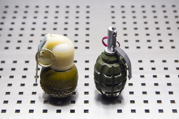 two hand-held fragmentation grenades close-up