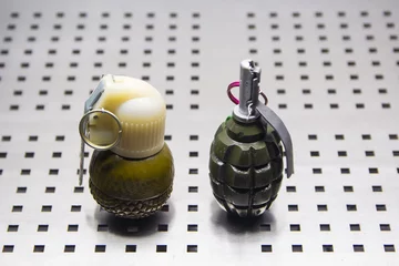 Poster two hand-held fragmentation grenades close-up © aleksmark2016