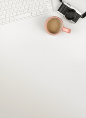 flat lay of computer keyboard, digital camera and a cup of coffee on white background. A4 size