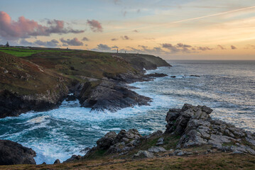 Stunning sunset landscape image of Cornwall cliff coastline with tin mines in background viewed...