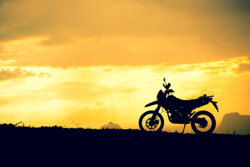 Fototapeta na wymiar Motocross bike in mountain view with beautiful evening lights. motorcycle travel concept