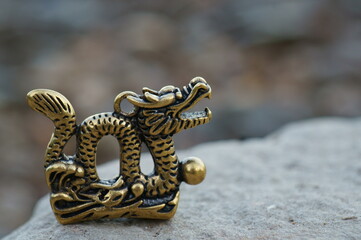 A metal dragon figurine. Feng Shui and esotericism. Chinese horoscope. Healing power.