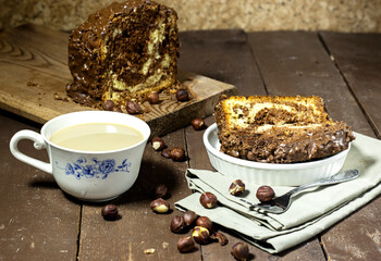 Delicious homemade marble pound cake with bottle of milk and hazelnuts
