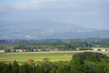 Fototapeta na wymiar Farmlands and windmills view from Palmerston North