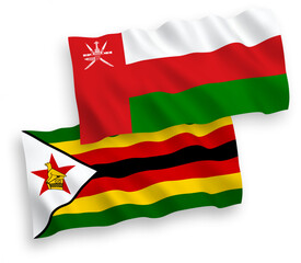 National vector fabric wave flags of Sultanate of Oman and Zimbabwe isolated on white background. 1 to 2 proportion.