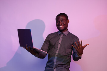 african man holding a laptop
