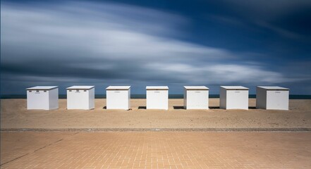 Long exposure of a row of beach huts on the beach of the North Sea in Koksijde, Belgium