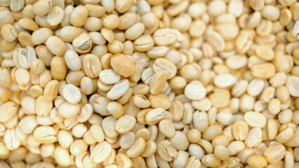 Closeup and top view raw coffee beans background.