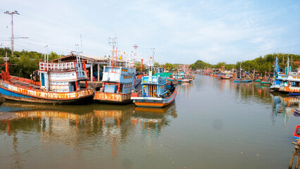 Fototapeta na wymiar Group of old fishing boats docked in the fishing village of Thailand, Phetchaburi.