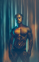Multicolored creative artistic portrait of a sexy muscular young man with net outfit on a colorful rainbow lighting and background. - obrazy, fototapety, plakaty