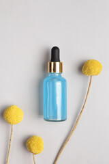 Essential oil or serum with floral extracts craspedia flowers. Hyaluronic acid oil, serum with collagen and peptides.