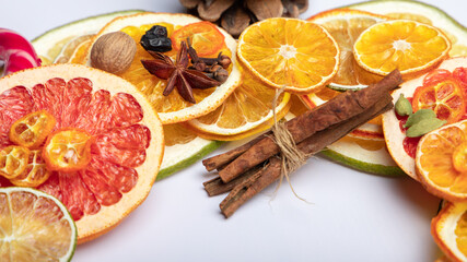 dried citrus fruit and slices of red lemon, orange, cinnamon, nuts, star anise, grapefruit. spices...