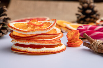 christmas composition with dried oranges and cinnamon sticks on wooden background