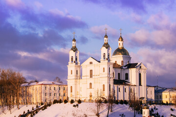 Fototapeta na wymiar Vitebsk, Belarus. Morning View Of Famous Landmark Is Assumption Cathedral Church In Upper Town On Uspensky Mount Hill In Sunrise Illumination. Soft Colors. Cathedral On Background Toned Cloudy Sky.