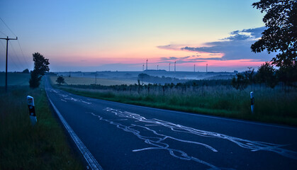 Road in the morning dawn before sunrise. Peaceful landscape in Germany