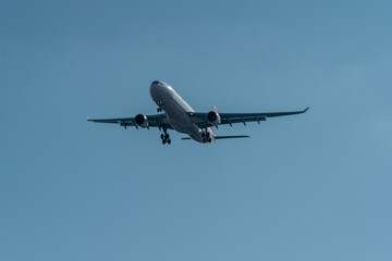Closeup a commercial passenger aircraft full of tourists approaching the destination airport after a long flight.