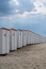 Vertical shot of a series of beach huts close to the North Sea in Belgium