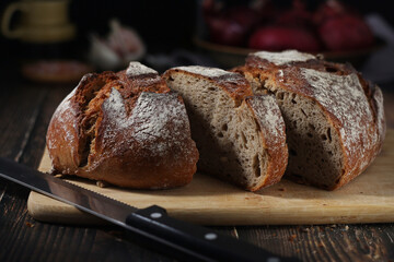 A loaf of rye bread in low key