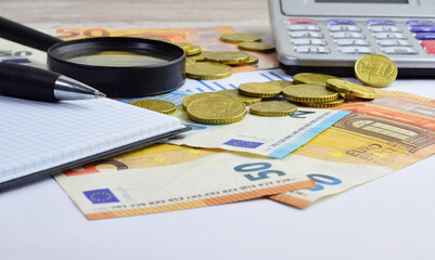 Consumption, bills, payments and tax increases, inflation, scattered euros, calculator and various, economic concept.
