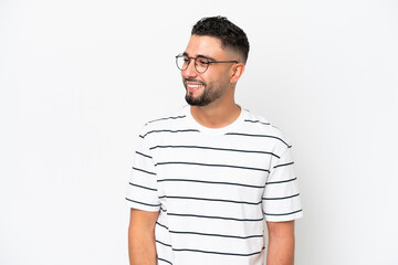 Young Arab handsome man isolated on white background looking to the side and smiling