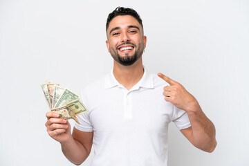 Young Arab man taking a lot of money isolated on white background giving a thumbs up gesture