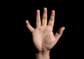 A human hand on a black background