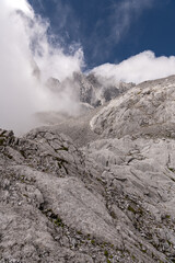 Beautiful view of the Jade Dragon Snow Mountain in the dense white cloud from the Lijiang Downtown, Yunnan province, China.