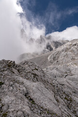 One of the many peaks of the Jade Dragon Snow Mountain with a beautiful blue sky and low cloud