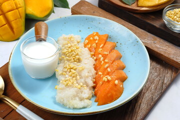 fresh ripe mango and sticky rice with coconut milk, is popular traditional dessert of...