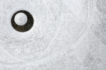 A close-up of a bubble of air trapped under ice
