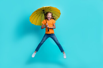 Full body length photo of young cute preteen girl wear casual outfit windy rainy forecast wrong hold parasol excited isolated on aquamarine color background