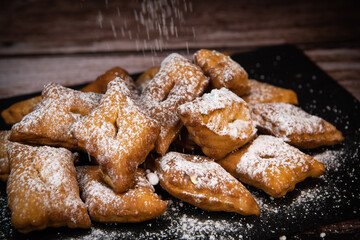 TRADITIONAL WONDERS OF SOUTH-WESTERN FRANCE, SPRINKLED WITH ICING SUGAR AND FLAVOURED WITH RUM AND ORANGE FLOWER WATER, High quality photo