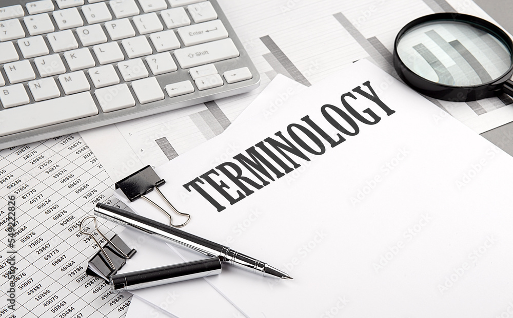 Poster terminology text on paper with chart and keyboard, business concept