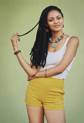 Fashion, beauty and portrait of black woman on green background in studio with creative, exotic and designer jewellery. Summer, African style and happy girl with braids, cosmetics and trendy clothing