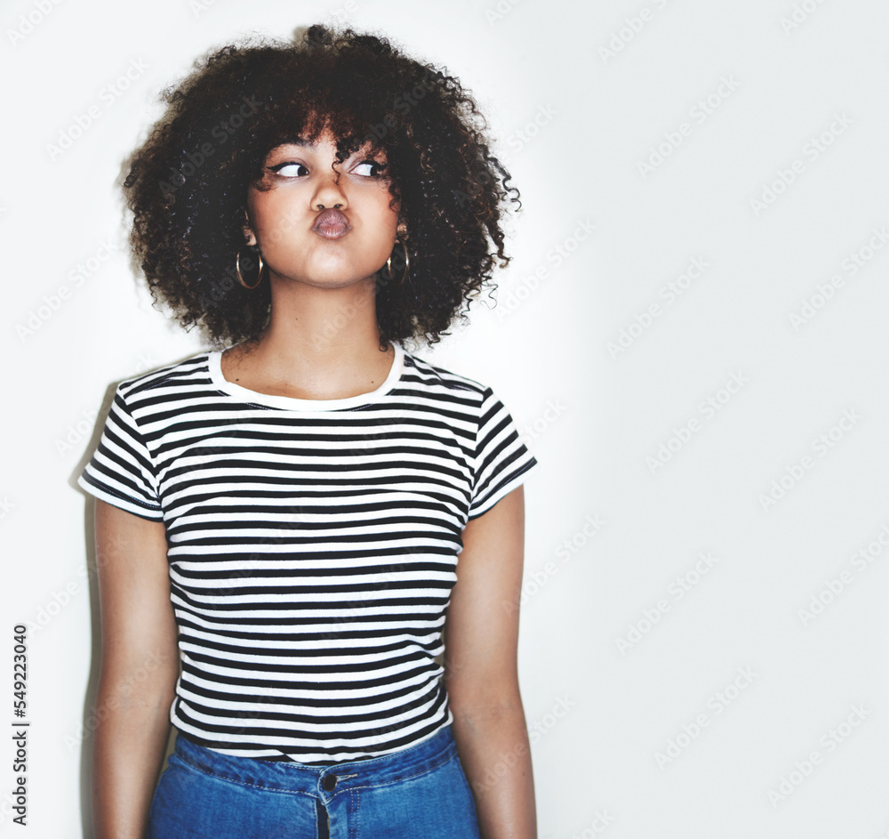 Wall mural Young black woman, funny face and playful with lips pout, comic, crazy and gen z youth with studio background. Comedy, goofy and silly facial expression, fashion and trendy with body language mock up